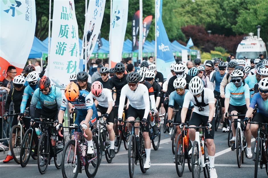 competitive cyclists enjoy an island tour on china tourism day