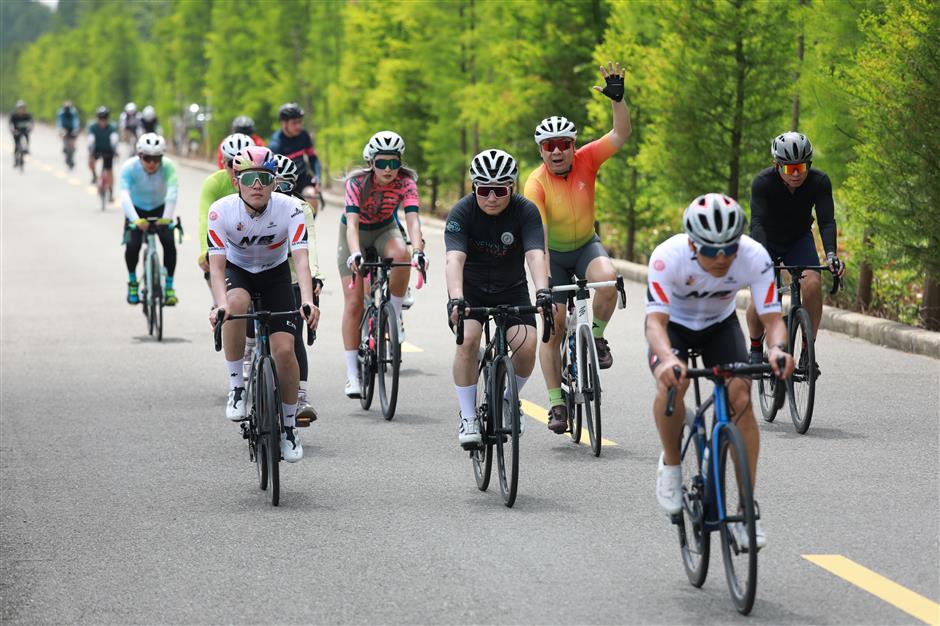 competitive cyclists enjoy an island tour on china tourism day